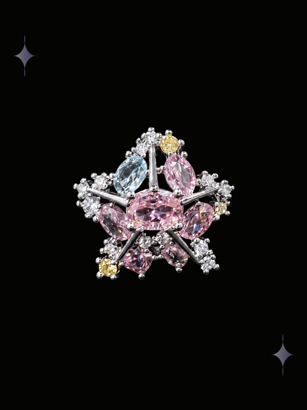 Aurora Star Y2K sparkling crystal star ring with pink, blue, and yellow cubic zirconia on a black background