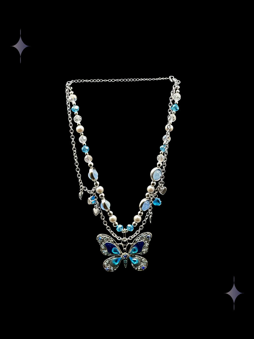 Azure Butterfly Y2K blue butterfly beaded necklace with faux pearl accents and silver-tone chains on a black background