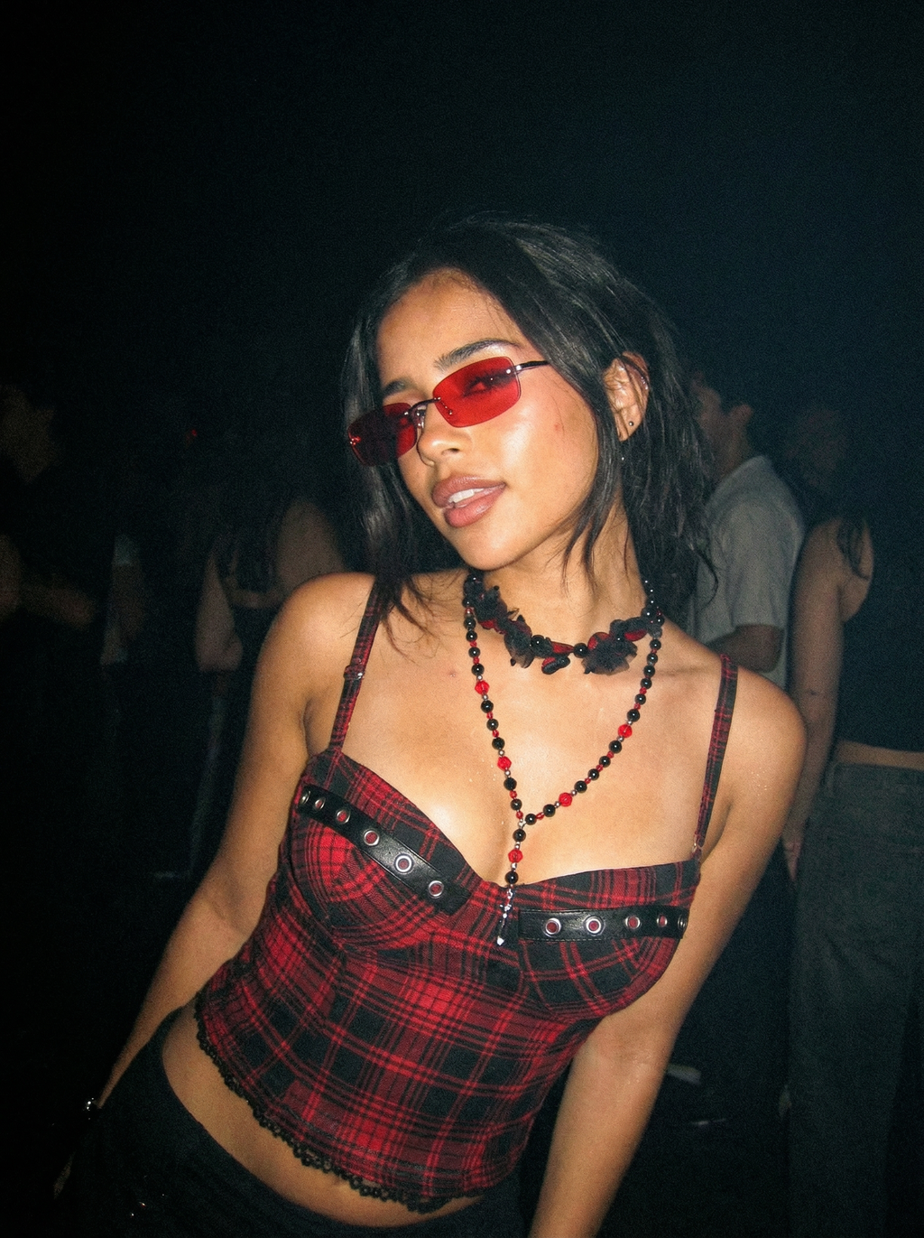 Model wearing the Black Cherry gothic red and black beaded necklace at a dark nighttime event