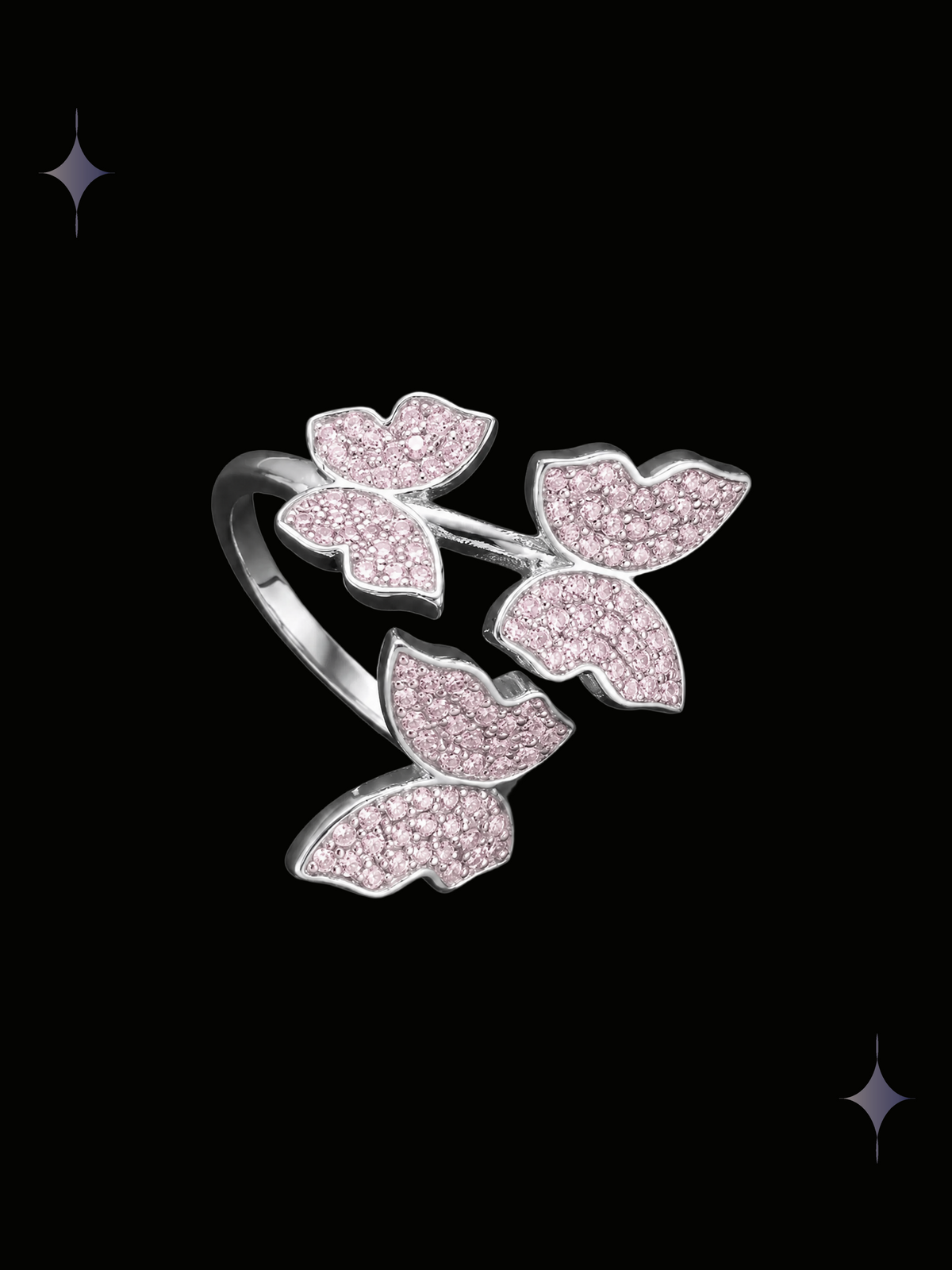 Blush Butterfly Y2K sparkling pink crystal ring with three cubic zirconia butterfly motifs and silver-tone details on a black background