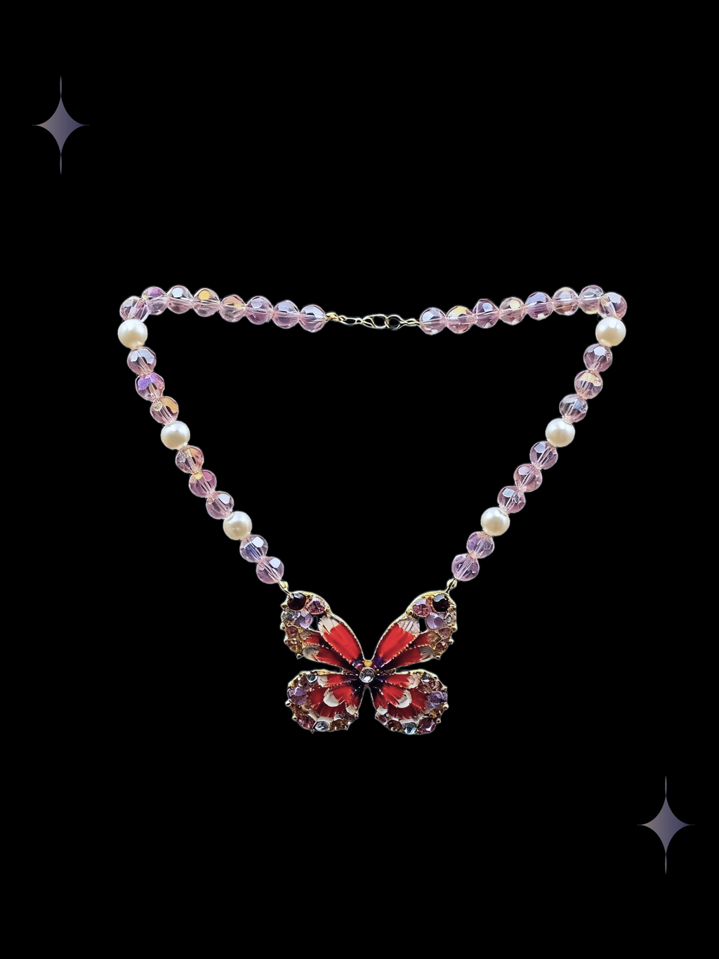 Crimson Butterfly Y2K red butterfly beaded necklace with rose-pink crystal beads, faux pearl accents, and a sparkling butterfly centerpiece on a black background