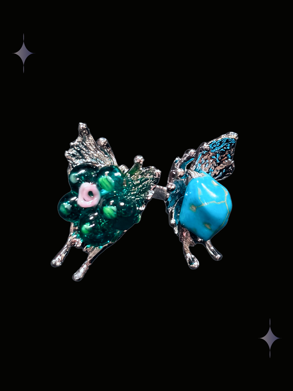 Handcrafted turquoise butterfly Y2K ring with teal green floral beads, turquoise-style stone and silver-tone butterfly details on a black background