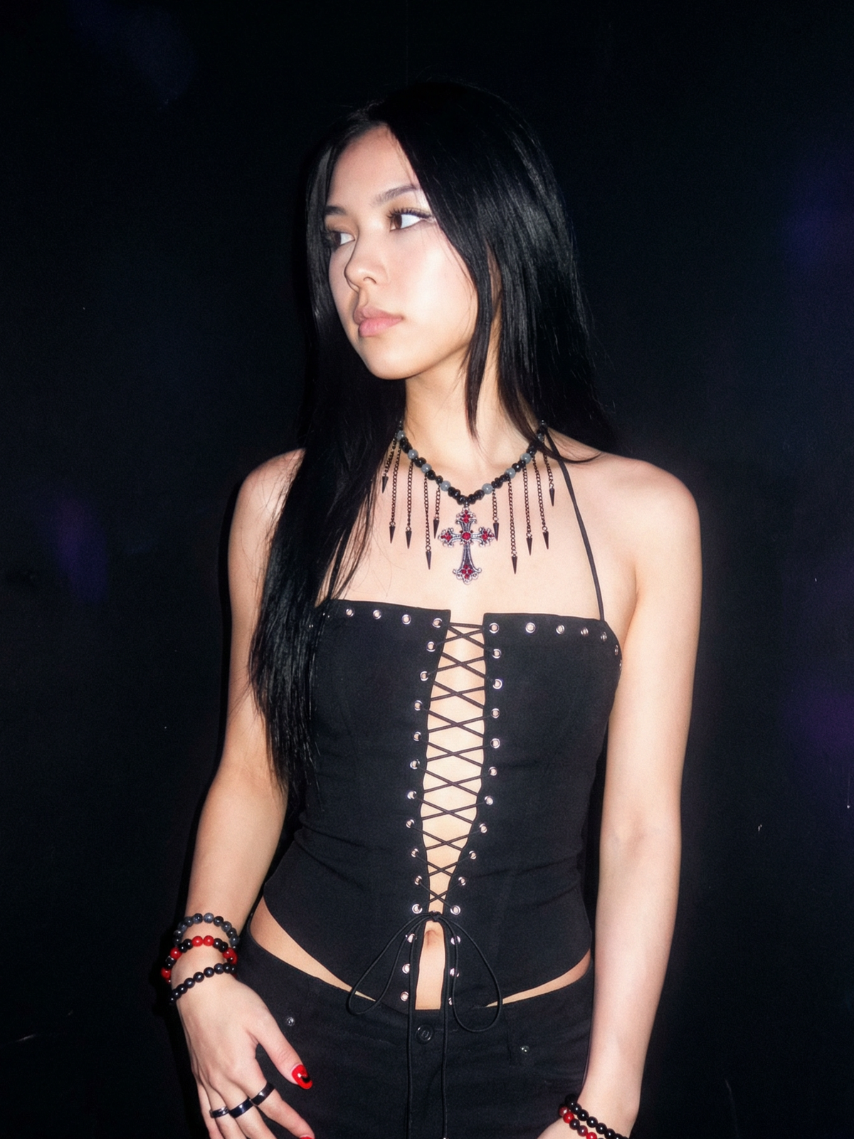 Model wearing the Midnight Cross gothic layered cross necklace against a dark studio background