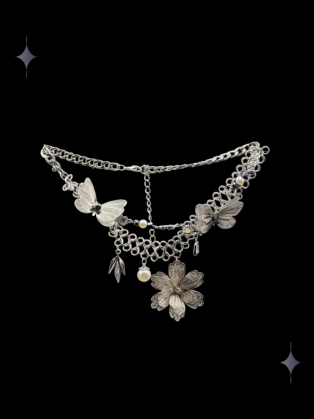 Moonflower Lace Y2K silver floral layered necklace with white butterfly charms, faux pearl drops, and a flower centerpiece on a black background