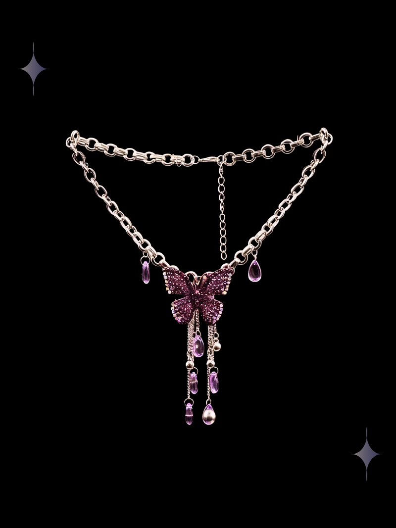 Petal Drip Y2K pink butterfly pendant necklace with purple teardrop accents and dangling silver-tone chains on a black background