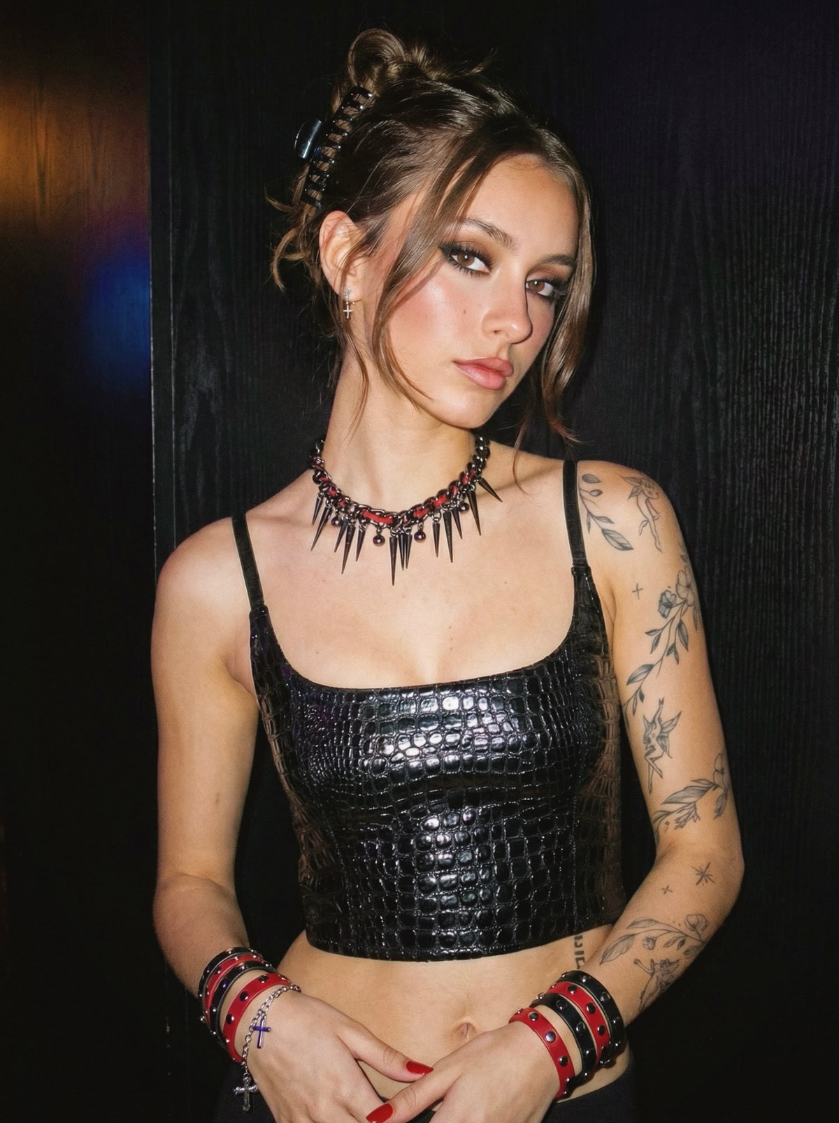 Model wearing the Riot Stitch gothic punk spike choker against a dark background