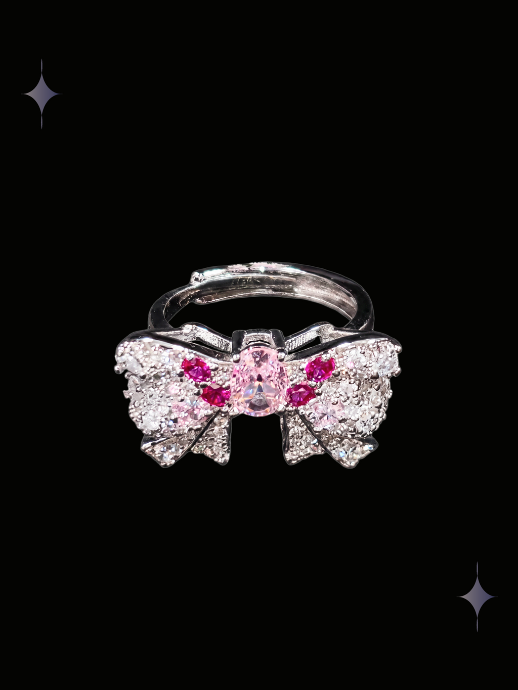 Roselight Bow Y2K sparkling pink crystal bow ring with clear cubic zirconia and silver-tone ribbon details on a black background