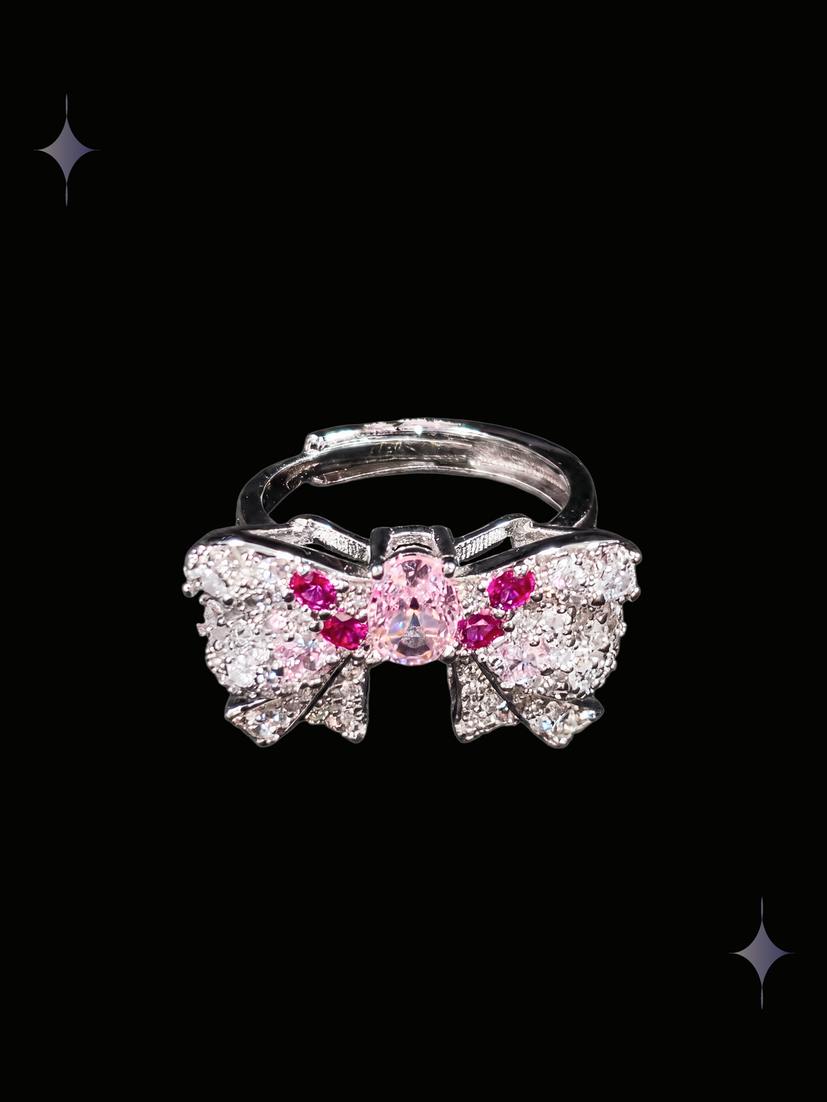 Roselight Bow Y2K sparkling pink crystal bow ring with clear cubic zirconia and silver-tone ribbon details on a black background