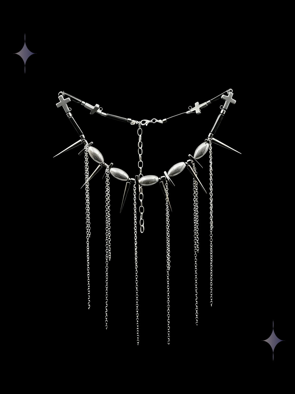 Spine Drip gothic spiked chain fringe necklace with gunmetal beads, pointed charms, cross details, and long silver-tone chain drops on a black background