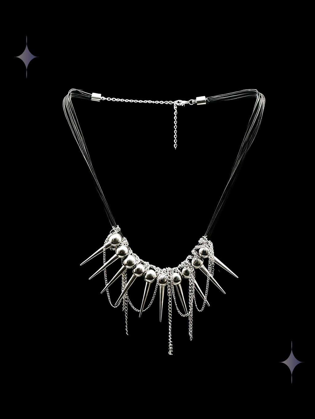 Spine Halo gothic spike collar necklace with silver-tone beads, pointed charms, and layered dangling chains on a black background