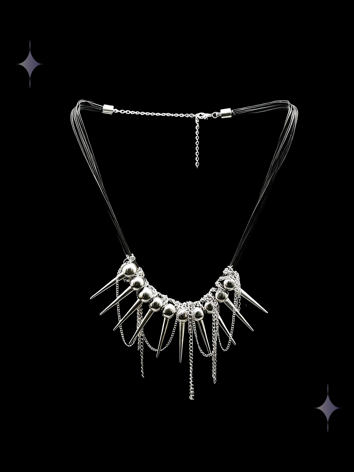 Spine Halo gothic spike collar necklace with silver-tone beads, pointed charms, and layered dangling chains on a black background