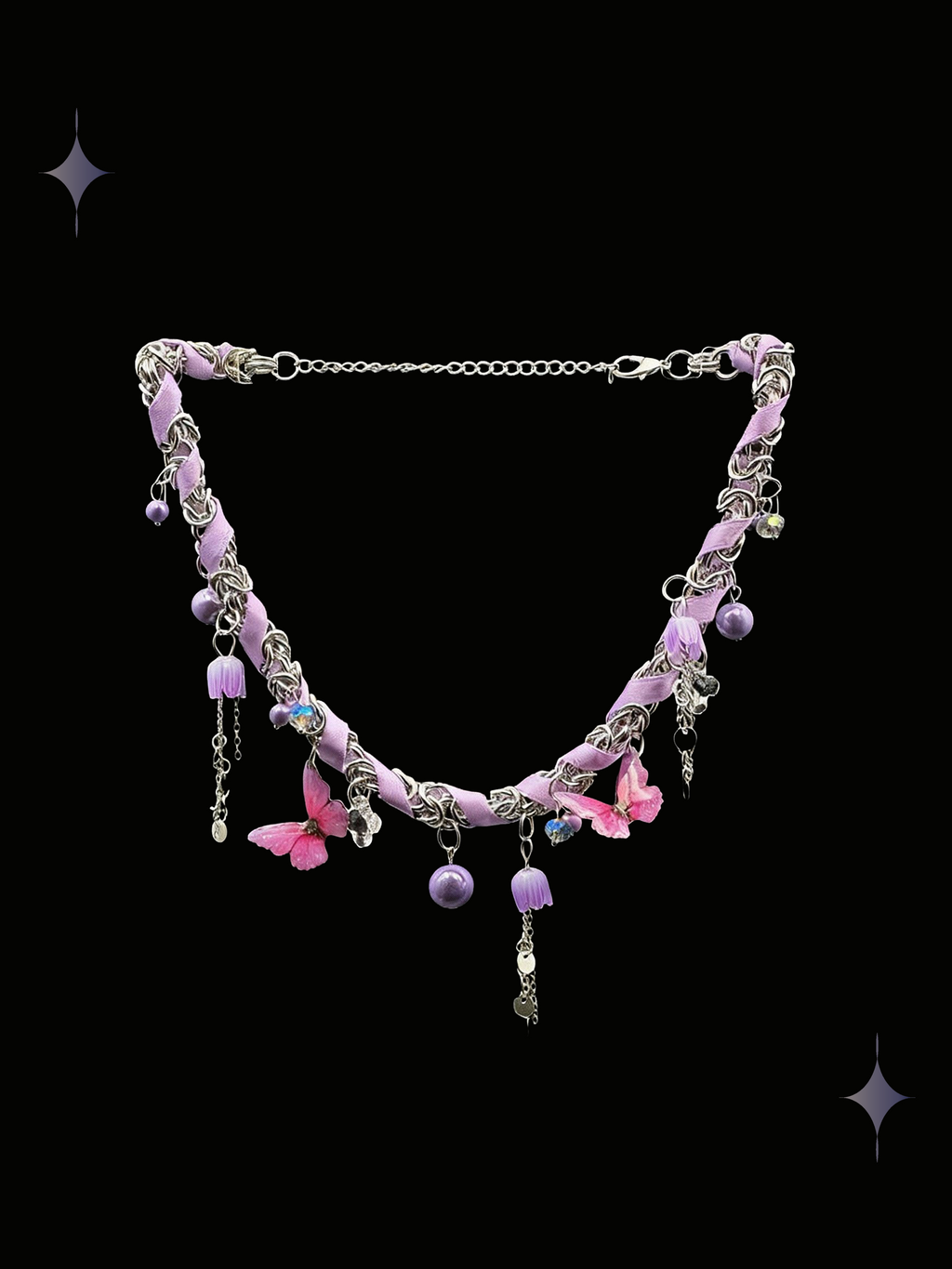 Starlit Petal pink floral charm necklace with lavender beads, ribbon details, and dangling silver-tone accents on a black background