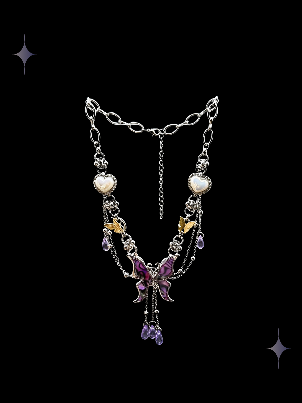 Twilight Butterfly purple butterfly statement necklace with pearl-heart accents, purple crystal drops, layered silver-tone chains, and gold-tone butterfly charms on a black background